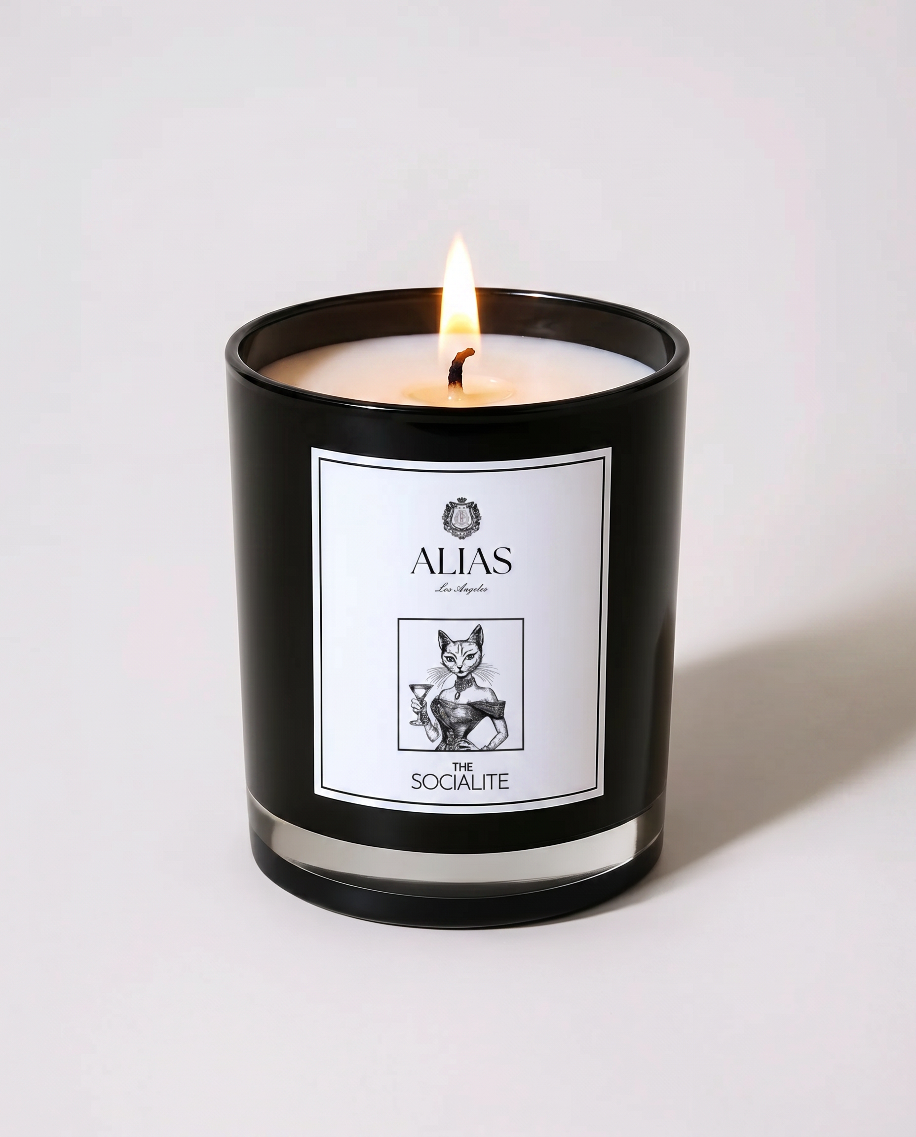 The Socialite luxury candle by Alias Los Angeles – glossy black jar with a sophisticated blend of jasmine, saffron, and amber; a glamorous soy wax candle perfect for entertaining, stylish home décor, and elegant gifting
