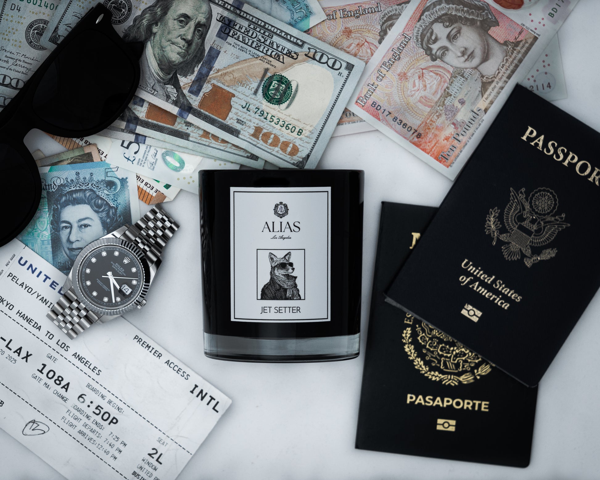 The Jet Setter candle by Alias Los Angeles styled among the refined essentials of a seasoned traveler—set against a backdrop of private jet interiors and five-star resort indulgence, this scene captures the spirit of those who chase sunsets in Santorini, wake up in Maldives villas, and carry the scent of Sicilian Bergamot, Black Tea, and Cedarwood wherever they go.