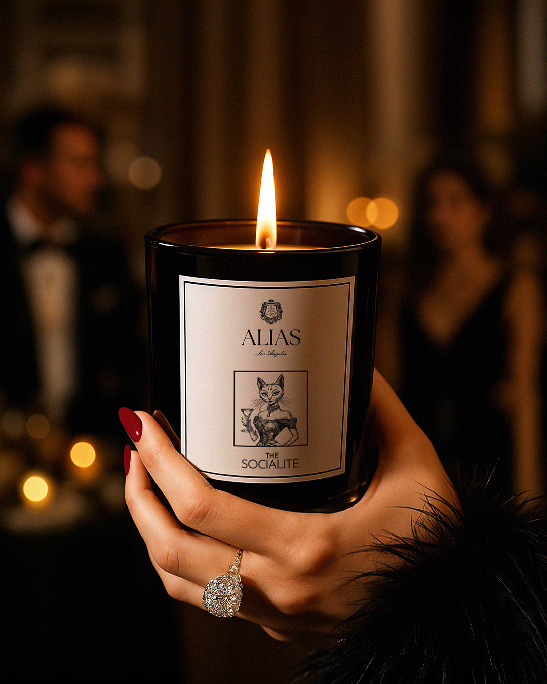 The Socialite luxury candle by Alias Los Angeles – glossy black jar featuring an opulent blend of jasmine, saffron, and amber; a glamorous soy wax candle perfect for entertaining, gifting, or elevating any modern space.