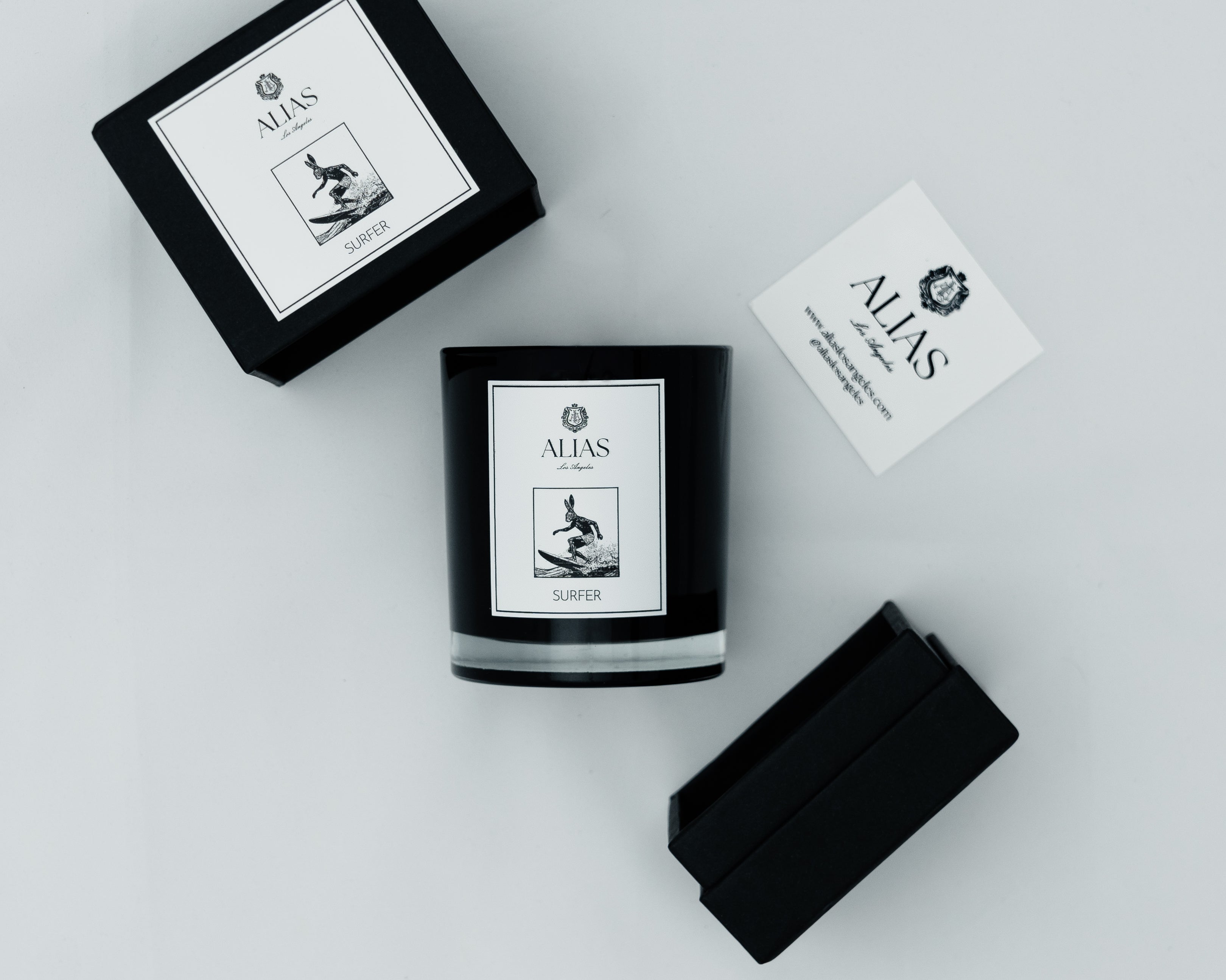 The Surfer candle by Alias Los Angeles showcasing a coastal inspired scent blend of sea spray ylang ylang birchwood and koa wood in elegant packaging